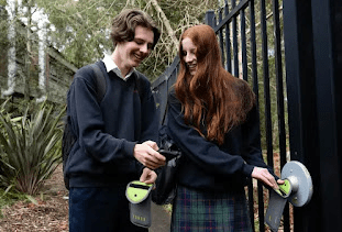 Davidson High School year 10 students  with the pouches used by the school to limit phone usage during school hours.