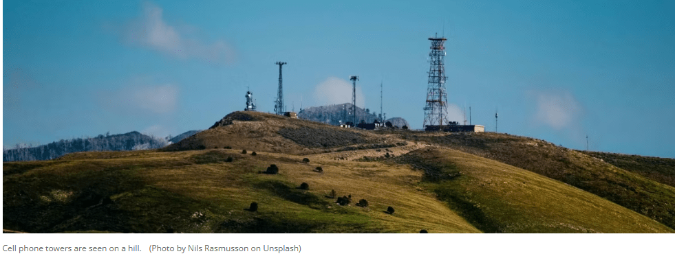 Cell phone towers are seen on a hill